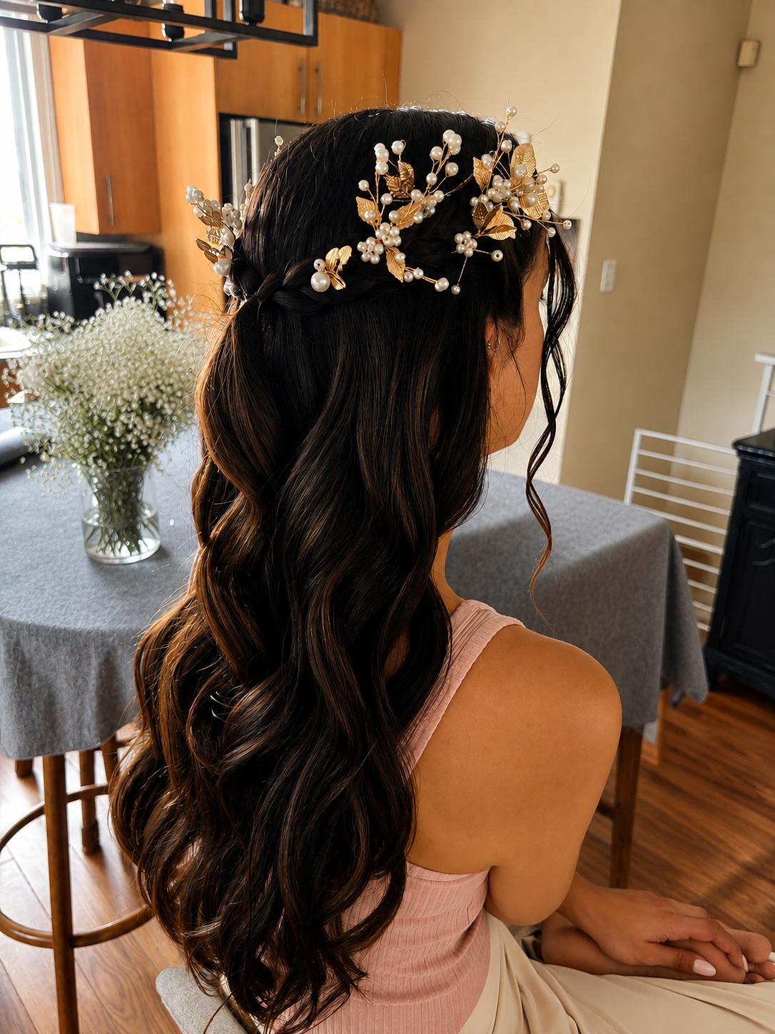 Bridal half-up style woven with a pearl and gold hair vine