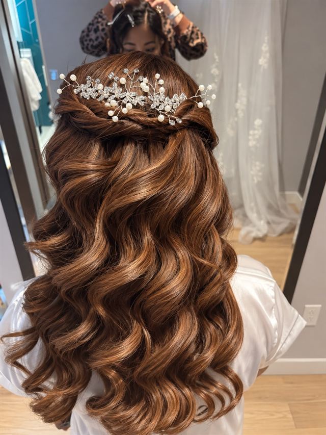 Copper-brown curls, half-up with a twist and a pearl and crystal comb