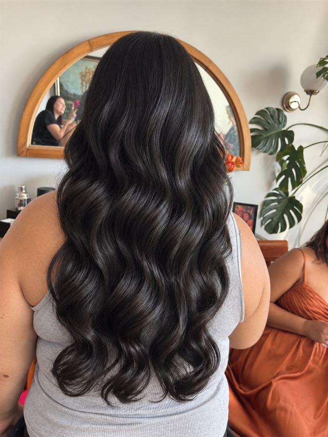 Long espresso brunette in glossy, defined waves, seen from behind