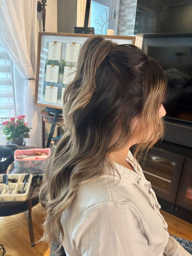 Half-up ponytail on brunette balayage with soft face-framing pieces