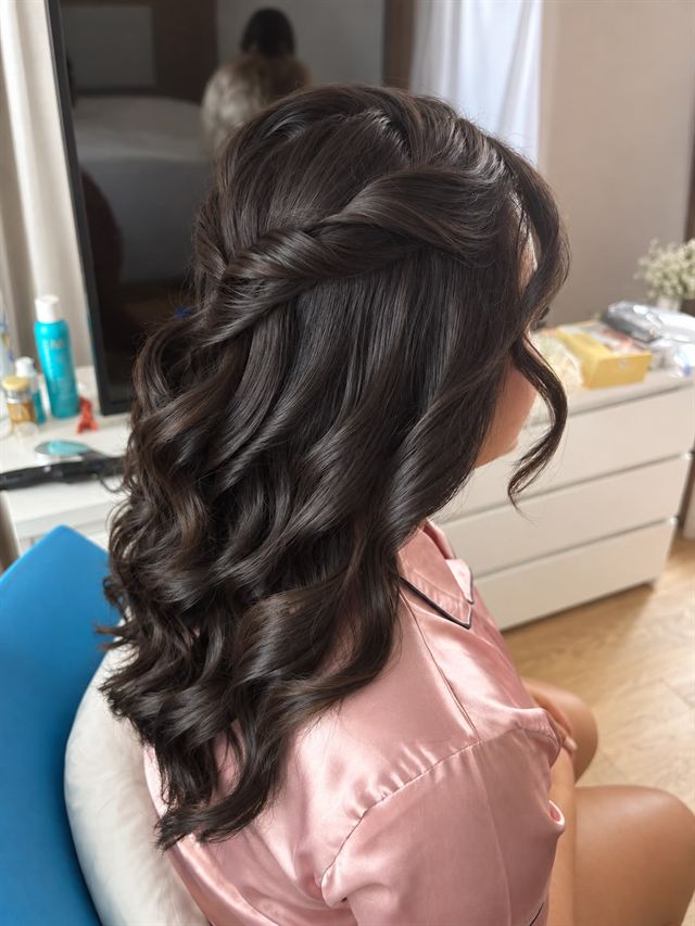 Dark brunette curls with a twisted half-up section